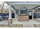 Outdoor covered bar and kitchen area with stone accents and barstool seating at 627 Rock Springs Rd, Lawrenceville, GA 30043