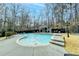 Backyard pool area featuring a well-maintained pool, surrounding patio, and cabana at 627 Rock Springs Rd, Lawrenceville, GA 30043