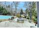 Inviting poolside patio area with fire pit and lounge chairs, perfect for relaxing and entertaining at 627 Rock Springs Rd, Lawrenceville, GA 30043