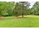 Spacious backyard featuring lush green grass and mature trees, creating a serene setting at 637 Rock Springs Rd, Lawrenceville, GA 30043