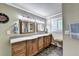 Bathroom with a dual sink vanity, wooden cabinets, tile flooring and neutral color palette at 637 Rock Springs Rd, Lawrenceville, GA 30043