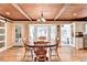 Bright dining room with a hardwood ceiling, light walls, and a large round wooden table at 637 Rock Springs Rd, Lawrenceville, GA 30043