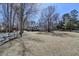 Property with a lush, expansive lawn and mature trees with a classic wooden fence at 637 Rock Springs Rd, Lawrenceville, GA 30043