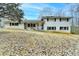 Charming two-story home with a classic white brick exterior and dark shutters, offering timeless curb appeal at 637 Rock Springs Rd, Lawrenceville, GA 30043