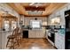 Functional kitchen showcasing white cabinets, black appliances, and a wood-paneled ceiling at 637 Rock Springs Rd, Lawrenceville, GA 30043