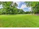 Large grassy lot featuring green lawn, mature trees, and a classic fence at 637 Rock Springs Rd, Lawrenceville, GA 30043