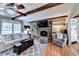 Comfortable living room boasts hardwood floors, a fireplace, and beamed ceilings at 637 Rock Springs Rd, Lawrenceville, GA 30043