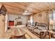 Cozy living room featuring wood paneling, brick fireplace, and comfortable seating at 637 Rock Springs Rd, Lawrenceville, GA 30043