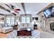 Cozy living room with wood beams, brick fireplace and stylish gray patterned rug and lots of natural light at 637 Rock Springs Rd, Lawrenceville, GA 30043