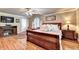 Comfortable main bedroom featuring hardwood floors, a fireplace, and sitting area with lots of natural light at 637 Rock Springs Rd, Lawrenceville, GA 30043