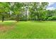 Lush backyard showcasing mature trees, green grass, and an old wooden fence at 637 Rock Springs Rd, Lawrenceville, GA 30043