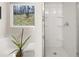 Bright bathroom featuring a soaking tub, a window and a glass enclosed shower at 9472 Cedar Grove Ct # 237, Jonesboro, GA 30238