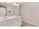 Bright bathroom features double sink vanity with white countertop and wood look flooring at 9472 Cedar Grove Ct # 237, Jonesboro, GA 30238