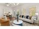 Bright living room with combined dining area, comfortable sofa, and stylish decor at 9472 Cedar Grove Ct # 237, Jonesboro, GA 30238