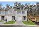 New construction townhomes featuring neutral siding and trim with attached garages and dark blue doors at 9474 Cedar Grove Ct # 238, Jonesboro, GA 30238