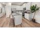 Bright kitchen with stainless steel appliances, white cabinetry, granite countertops, and wood flooring at 9474 Cedar Grove Ct # 238, Jonesboro, GA 30238