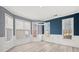 Well-lit dining room enhanced by wainscoting, multiple windows, and modern light fixture at 4526 Balto Way, Acworth, GA 30101