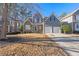 Charming two-story home featuring a stone facade, gray siding, well-maintained landscaping, and a two-car garage at 4526 Balto Way, Acworth, GA 30101