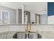 This kitchen features granite countertops, stainless steel sink with a gold faucet, and a view of the fireplace at 4526 Balto Way, Acworth, GA 30101