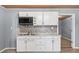 Close-up of kitchenette's cabinets, microwave, stainless steel sink and tile backsplash at 4526 Balto Way, Acworth, GA 30101