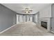 Large living room with plush carpet, a fireplace, and French doors leading to other areas of the home at 4526 Balto Way, Acworth, GA 30101