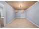 Neutral living area with laminate wood floors, overhead lighting, and ample wall space at 4526 Balto Way, Acworth, GA 30101