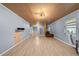 Spacious living room with laminate floors and a modern lighting fixture at 4526 Balto Way, Acworth, GA 30101