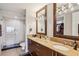 Bathroom featuring a double vanity, large mirrors, and a walk-in glass shower at 4561 Olde Perimeter Way # 2609, Atlanta, GA 30346