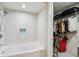 Bathroom with a white subway tile shower and bathtub combination, as well as a walk-in closet at 4561 Olde Perimeter Way # 2609, Atlanta, GA 30346