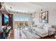 Bright living room featuring hardwood floors, a large window with an open view, and a comfortable white couch at 4561 Olde Perimeter Way # 2609, Atlanta, GA 30346