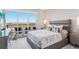 Bright main bedroom with a large window showing balcony and scenic views, complemented with modern furniture at 4561 Olde Perimeter Way # 2609, Atlanta, GA 30346