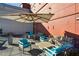 Charming outdoor patio with comfortable seating under a large umbrella offering the perfect space for relaxation at 4561 Olde Perimeter Way # 2609, Atlanta, GA 30346