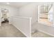 Hallway with carpet flooring leading to bedroom and staircase with window view at 9456 Magnolia Bend Way # 331, Jonesboro, GA 30238