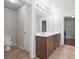 Well-lit bathroom featuring a double sink vanity, tile flooring, and a separate toilet area at 3546 Bridge Walk Dr, Lawrenceville, GA 30044