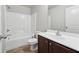 Bathroom featuring a shower-tub combo, vanity with storage, and easy-to-clean surfaces at 3546 Bridge Walk Dr, Lawrenceville, GA 30044