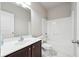Bathroom featuring a dark wood vanity, white countertop and shower/tub combo at 3546 Bridge Walk Dr, Lawrenceville, GA 30044
