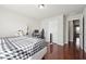 Comfortable bedroom with hardwood floors and a dedicated computer/workstation area at 3546 Bridge Walk Dr, Lawrenceville, GA 30044