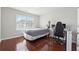 Bedroom with hardwood floors, a large window, and space for a bed and desk setup at 3546 Bridge Walk Dr, Lawrenceville, GA 30044