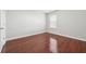 Minimalist bedroom with a large window and hardwood floors at 3546 Bridge Walk Dr, Lawrenceville, GA 30044
