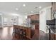 Open concept kitchen with dark wood cabinets, stainless appliances, and large island at 3546 Bridge Walk Dr, Lawrenceville, GA 30044
