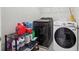 Laundry area featuring modern washer and dryer units, plus shelving for storage at 3546 Bridge Walk Dr, Lawrenceville, GA 30044