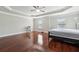 Large main bedroom boasting a tray ceiling, hardwood floors, and natural light from two windows at 3546 Bridge Walk Dr, Lawrenceville, GA 30044