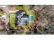 Drone's eye view of elegant home with swimming pool, large backyard, and a long driveway at 4555 Mystic Dr, Atlanta, GA 30342