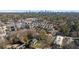 Scenic aerial shot of a neighborhood with mature trees and diverse buildings with the city skyline at 4555 Mystic Dr, Atlanta, GA 30342