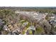 Aerial view of a residential neighborhood with tree-lined streets and modern homes with city view in the background at 4555 Mystic Dr, Atlanta, GA 30342