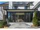 Back porch with brick patio and glass doors leading into a sunroom and backyard at 4555 Mystic Dr, Atlanta, GA 30342