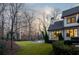 Beautiful backyard with a modern pool, lush green lawn, and an elegant white brick home exterior at 4555 Mystic Dr, Atlanta, GA 30342