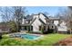 Lovely backyard with a sparkling pool, spa, and lush green grass, complemented by a modern home exterior at 4555 Mystic Dr, Atlanta, GA 30342