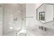 Modern bathroom featuring a glass-enclosed shower and geometric mirror over the vanity at 4555 Mystic Dr, Atlanta, GA 30342
