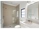 Modern bathroom features glass enclosed shower, a rectangular mirror, quartz counters, and neutral tile at 4555 Mystic Dr, Atlanta, GA 30342